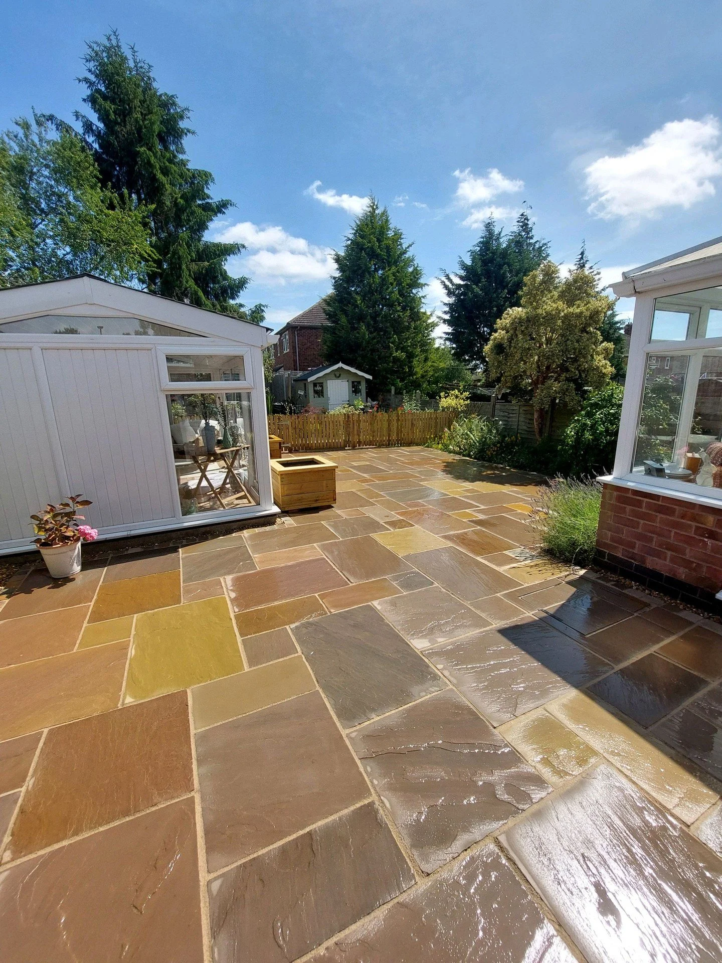 A repost on one of our favourite projects of 2025 for a great customer in Earl Shilton, Leicestershire. 

We installed 55sqm of buff Indian sandstone with a matching cobble edging, finished with our hand built timber planters and a timber picket fenc