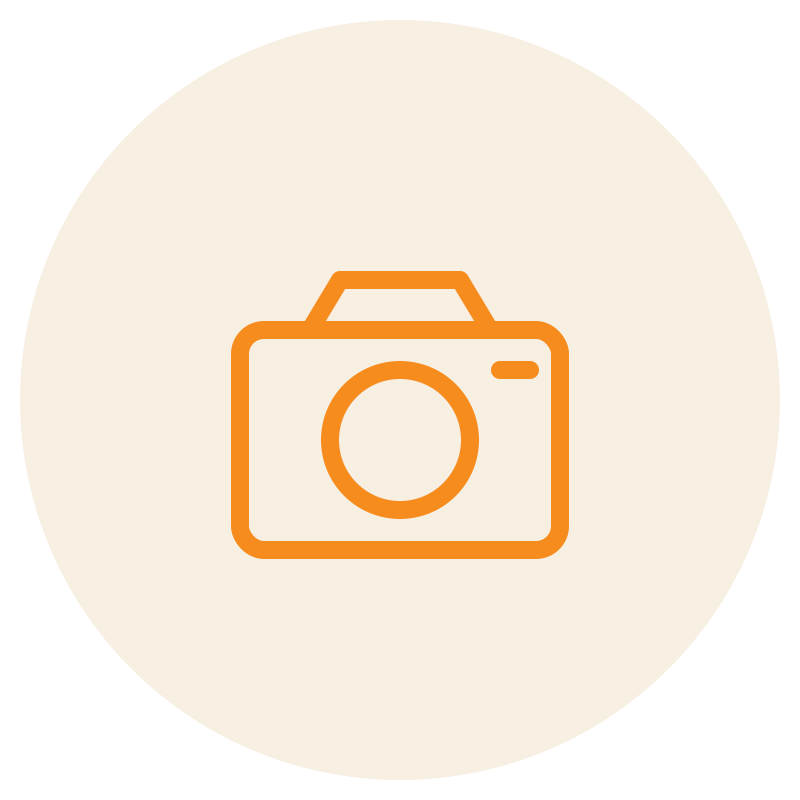 Icon of a camera with an orange outline on a beige circular background.