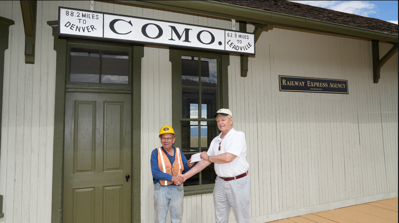 On July 18, 2026, Intermountain Chapter President, Robert Brewster, delivers a Chapter P-R-O check to Mr. Bob Schoppe, President of the Denver, South Park & Pacific Historical Society (DSPPHS). The funds are meant to complement the 2026 NRHS Heritage