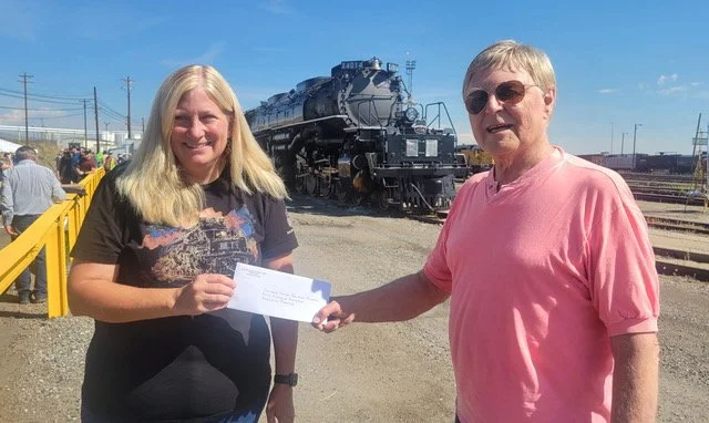 On July 28, 2026 at Union Pacific’s North Yard in Denver, Intermountain Chapter President,
Robert Brewster, presented a Chapter P-R-O Fund check to Michelle Kempena,
Executive Director of the Colorado Model Railroad Museum in Greeley. The Chapter’s
c