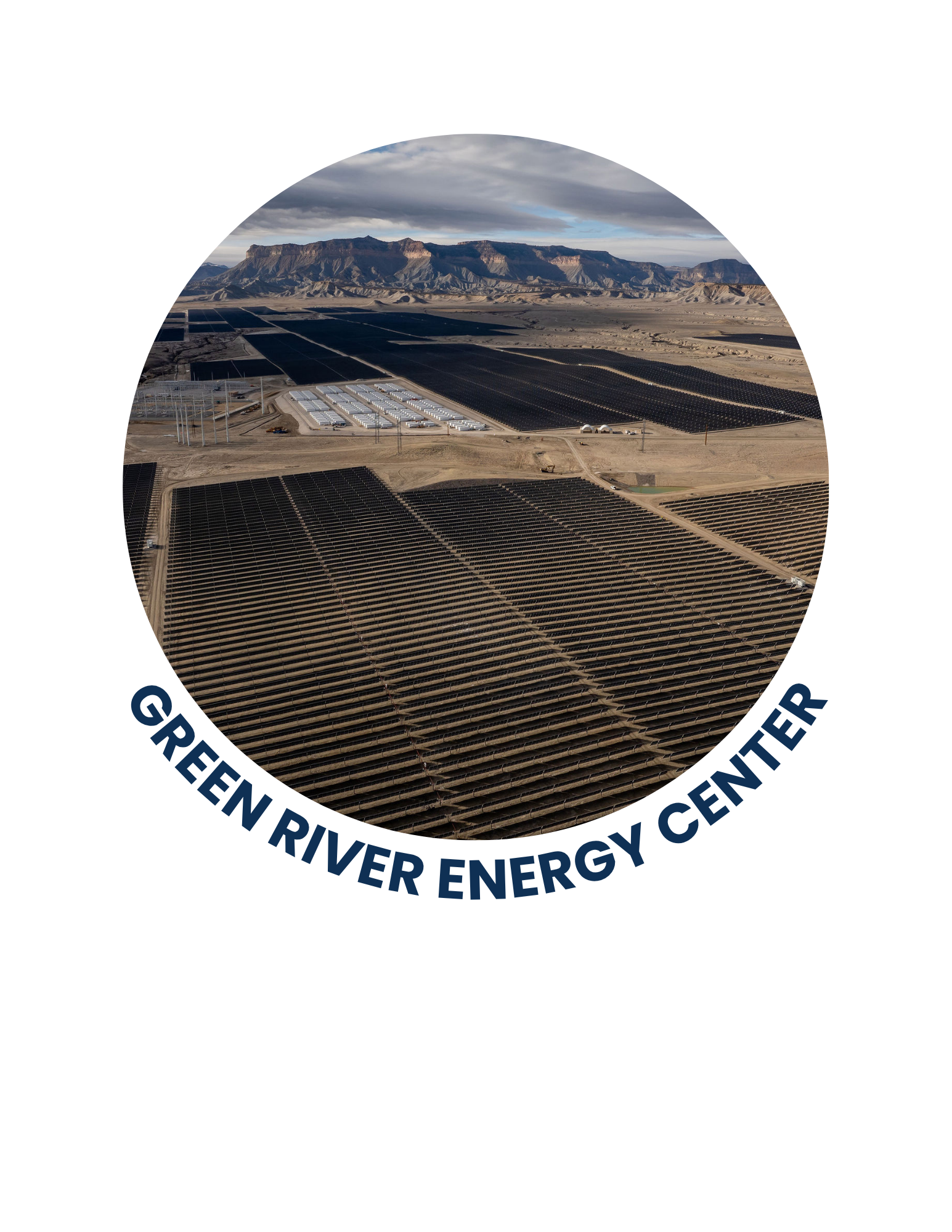 Aerial view of a solar farm with multiple solar panels in a desert landscape, mountains in the background.