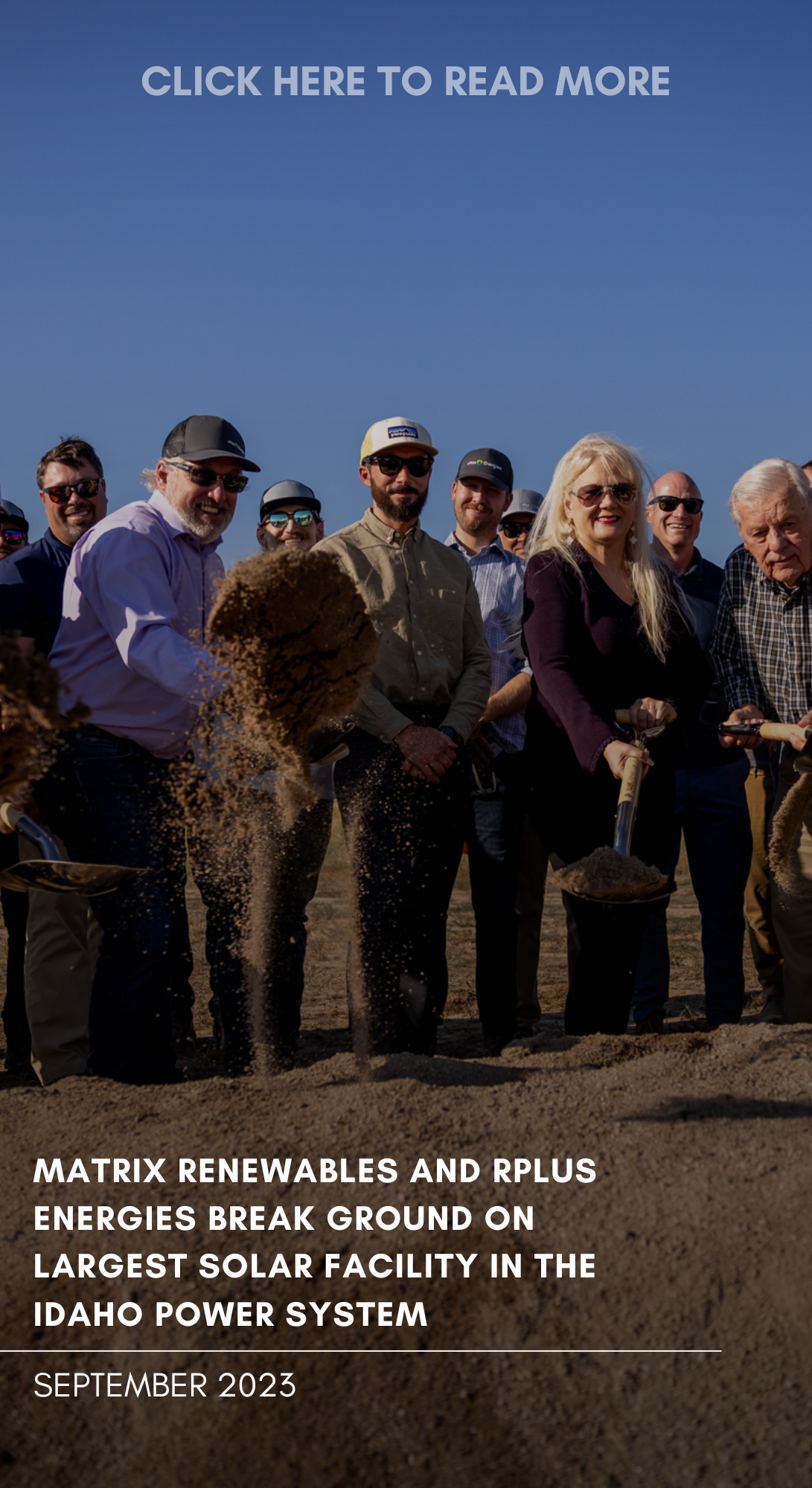 A group of people at a groundbreaking ceremony, some holding shovels with dirt, outdoors under a blue sky, celebrating the start of a large solar facility in Idaho, September 2023.