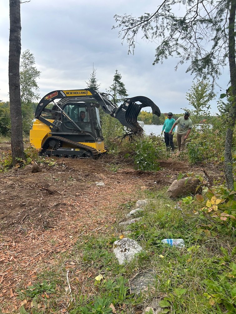 Landscape Equipment on worksite with workers.