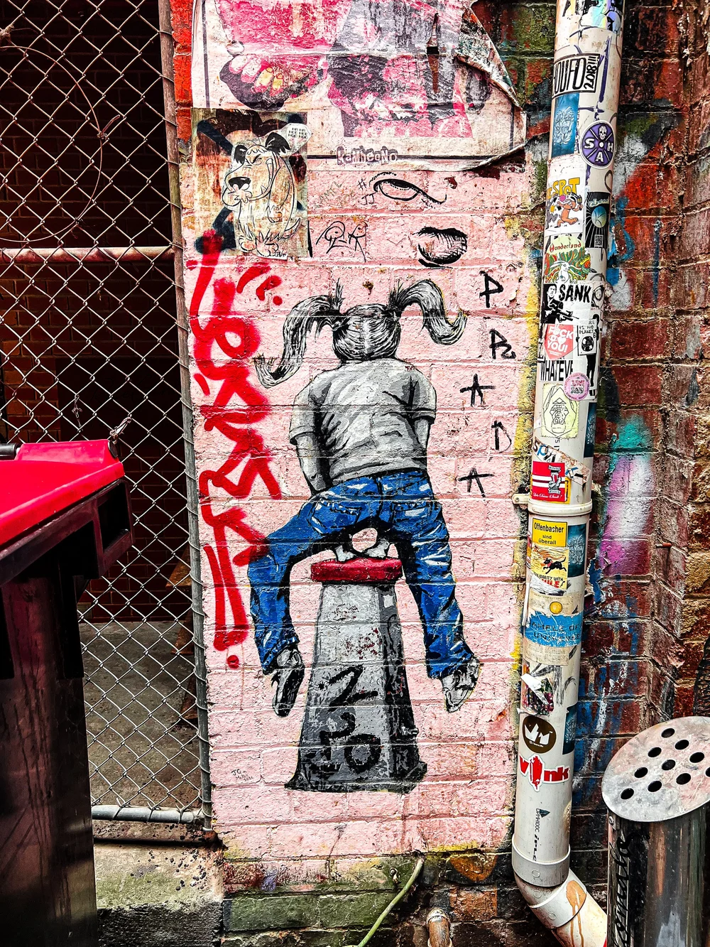Little girl playing hopscotch along Duckboard Pl