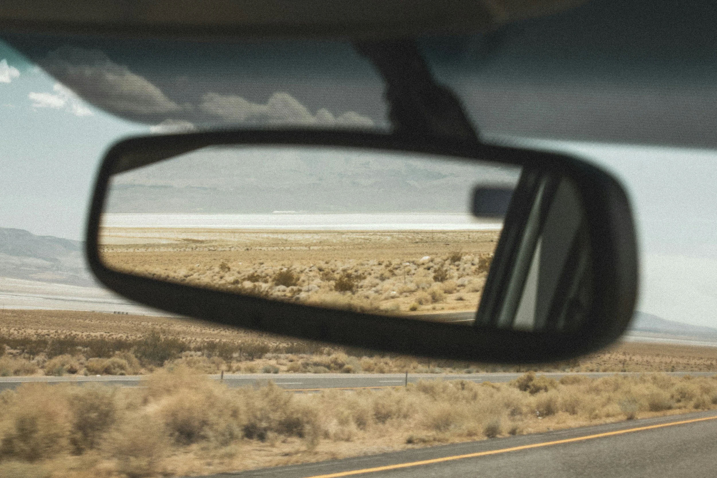 The Bitter Bitch Lifestyle Blog: The View from My Rearview.  Picture of a vast desert through the reflection of a car's rearview mirror
