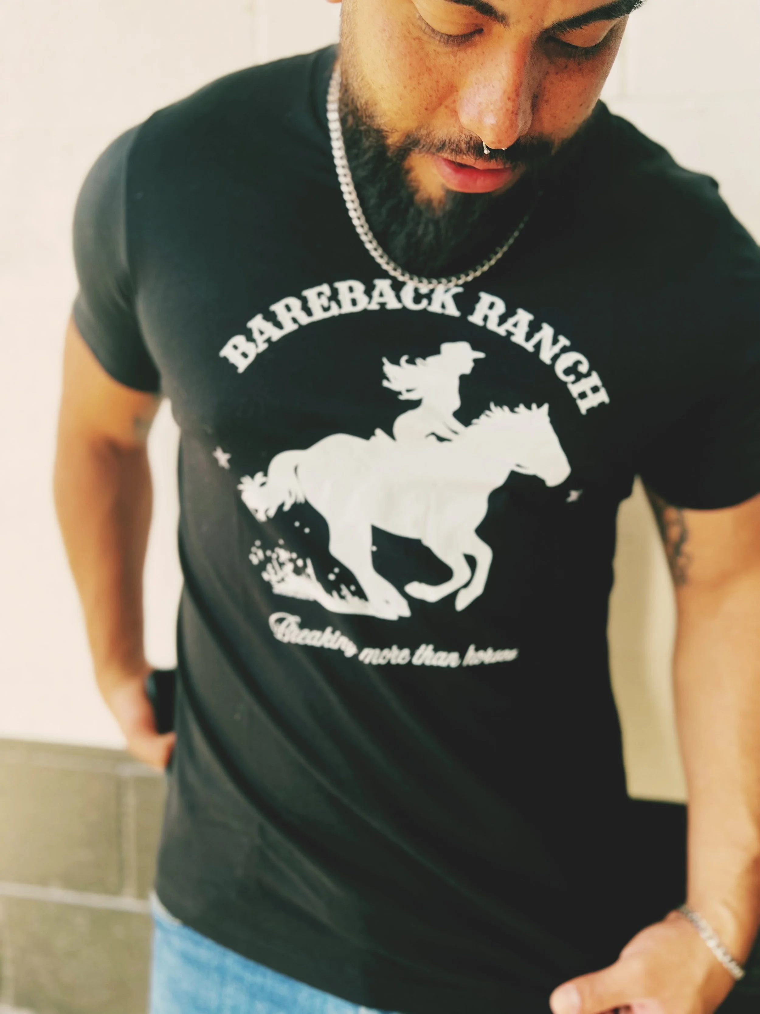 Bareback Ranch: Breaking more than horses unisex tee in black with bold white graphic, by The Bitter Bitch Co.