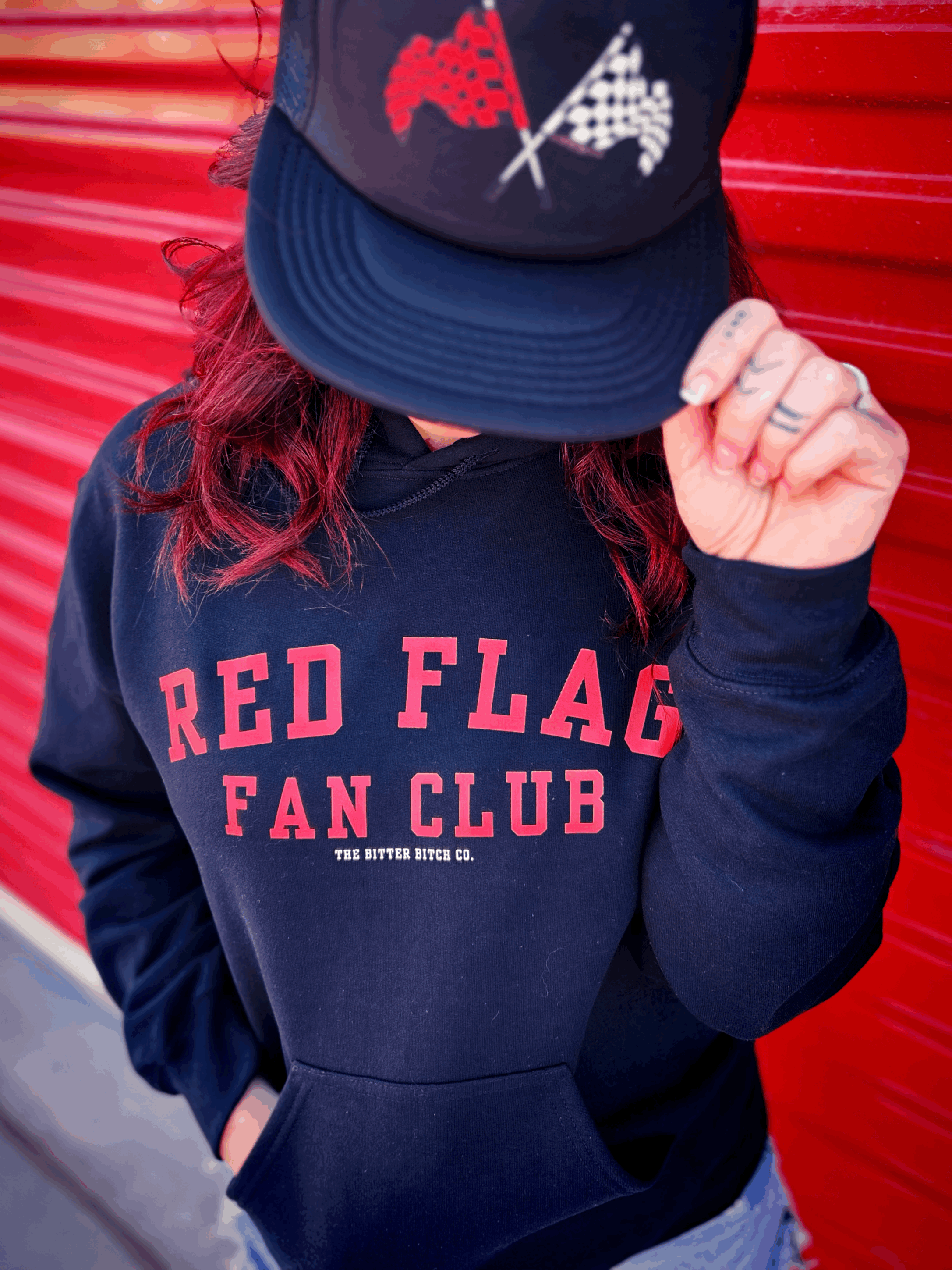 Red Flags Fan Club unisex hoodie in black with red and white checkered flag logo, for those who know red flags fuck better.  Part of the Red Flags Fan Club Collection by The Bitter Bitch Co