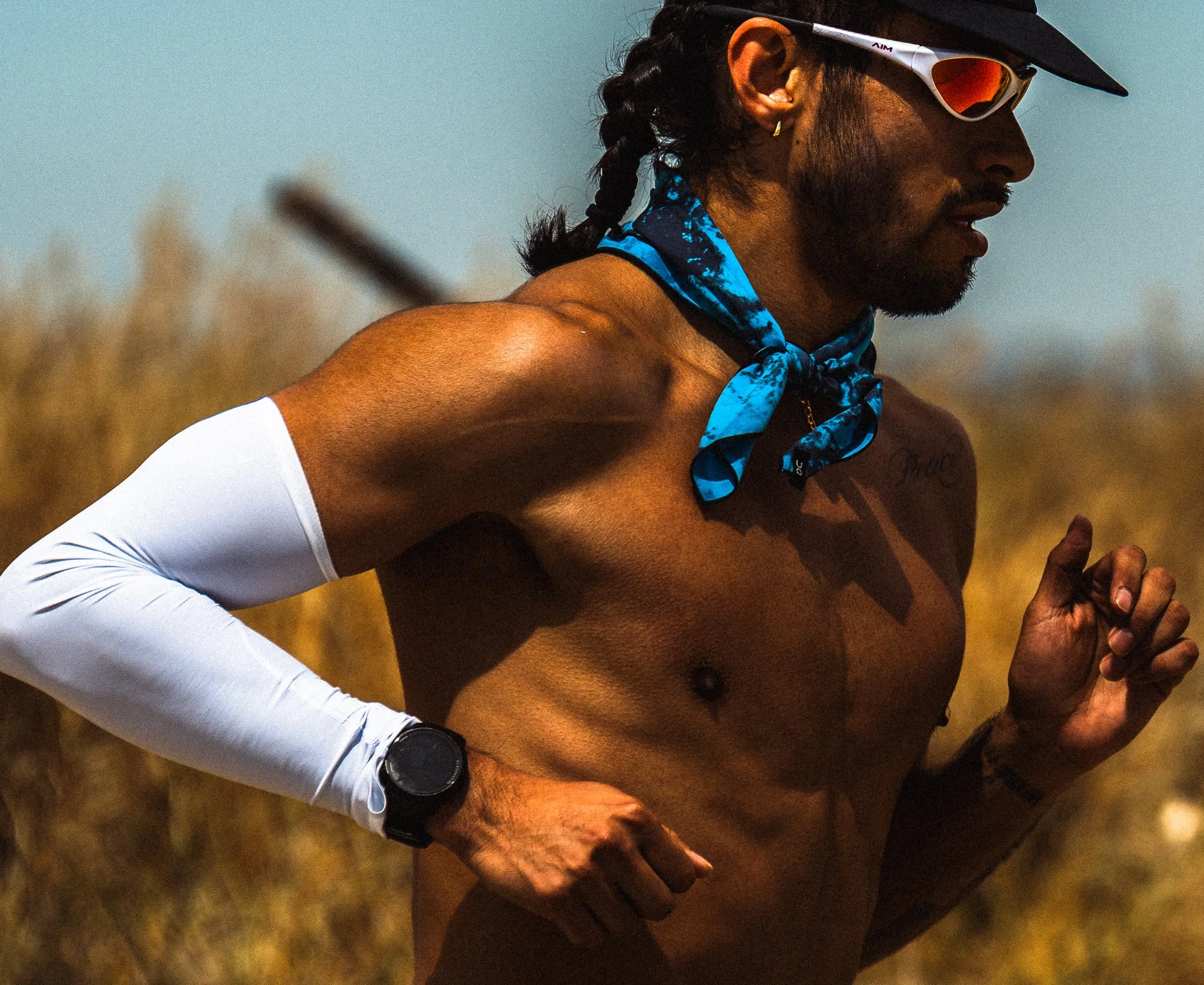 male athlete running wearing garmin - athletic brand photographer the speed project