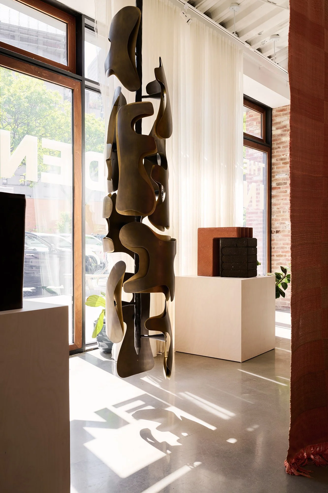 Okia pendant casting shadows on concrete floor