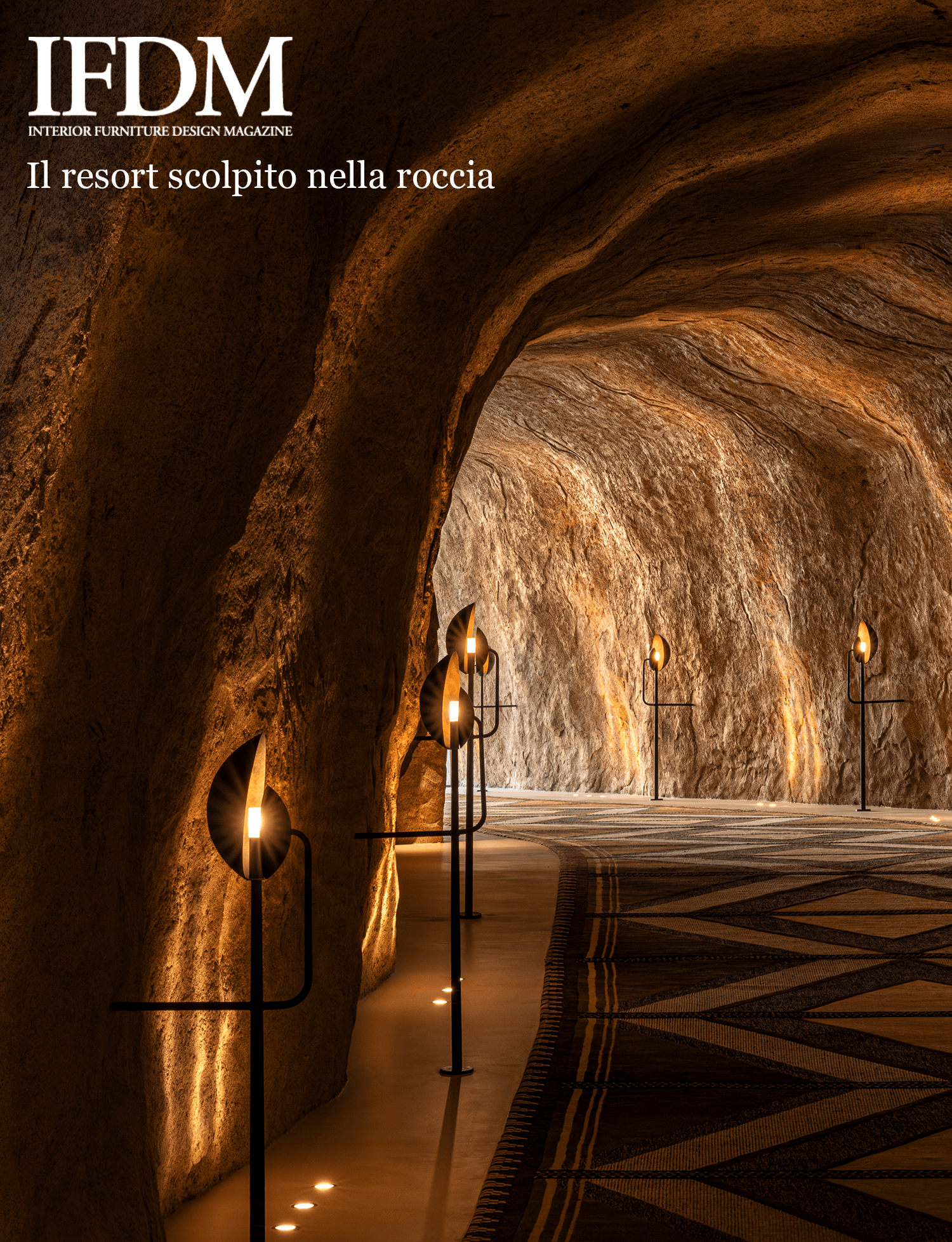 Illuminated rock passage with sculptural black floor lamps at Desert Rock resort.