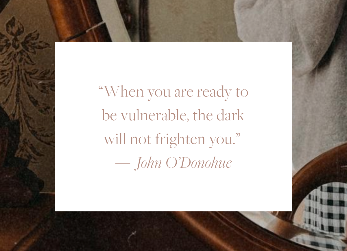 Quote reading “When you are ready to be vulnerable, the dark will not frighten you.” by John O’Donohue, displayed in soft serif text on a white background over a warm, textured backdrop.