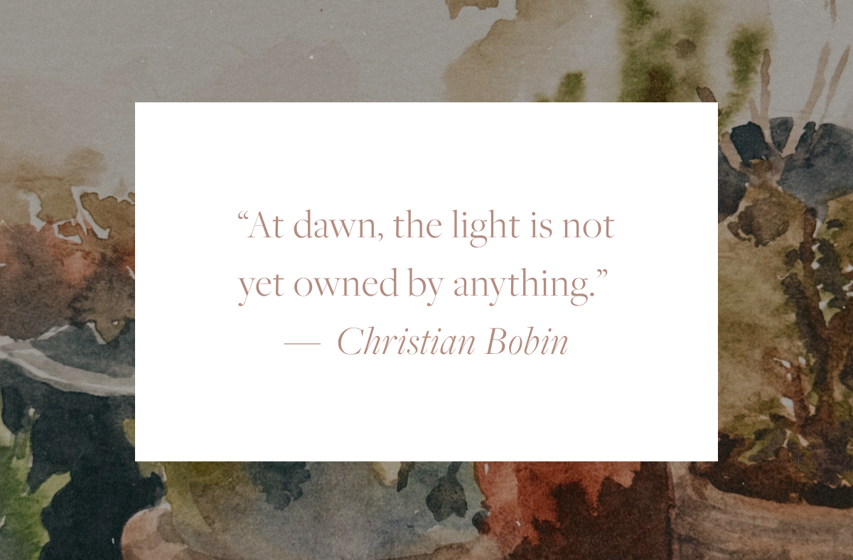 Quote reading “At dawn, the light is not yet owned by anything.” by Christian Bobin, displayed in soft serif text on a white background over a muted, watercolor-style backdrop.