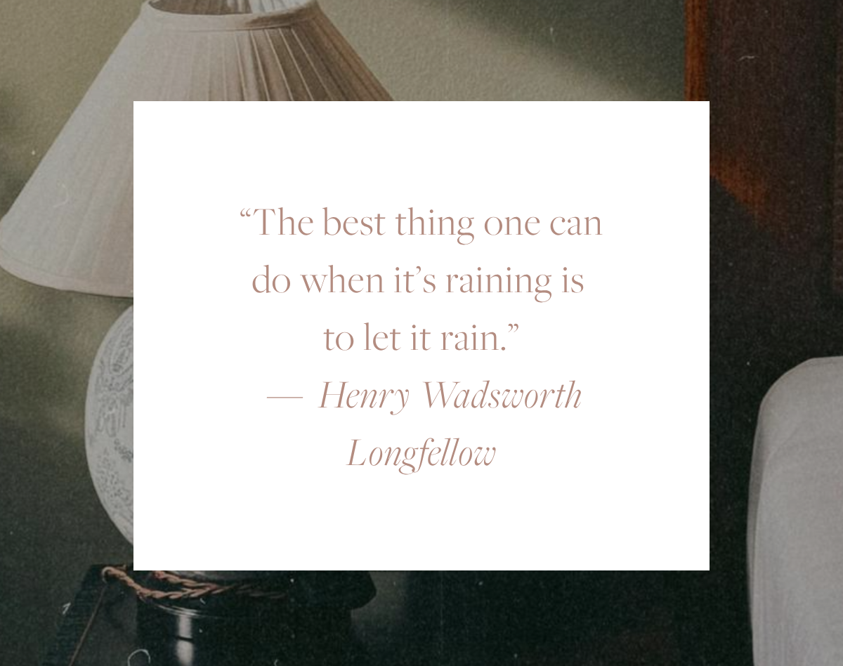 Quote card reading: "The best thing one can do when it's raining is to let it rain." — Henry Wadsworth Longfellow, overlaid on a moody interior photo with a soft lamp and armchair in the background.