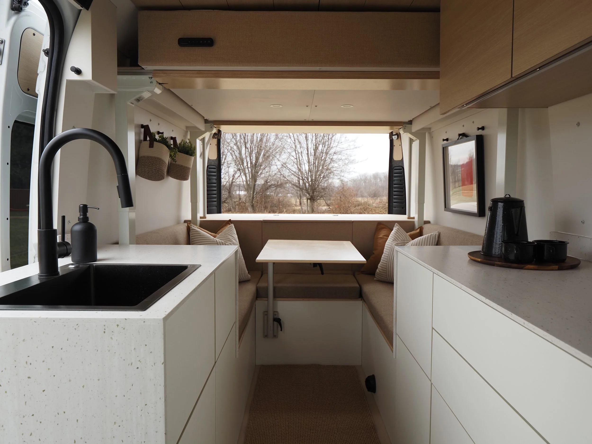 Full interior layout of Roamer Vans Signature Series Koselig conversion — kitchen, galley and lounge