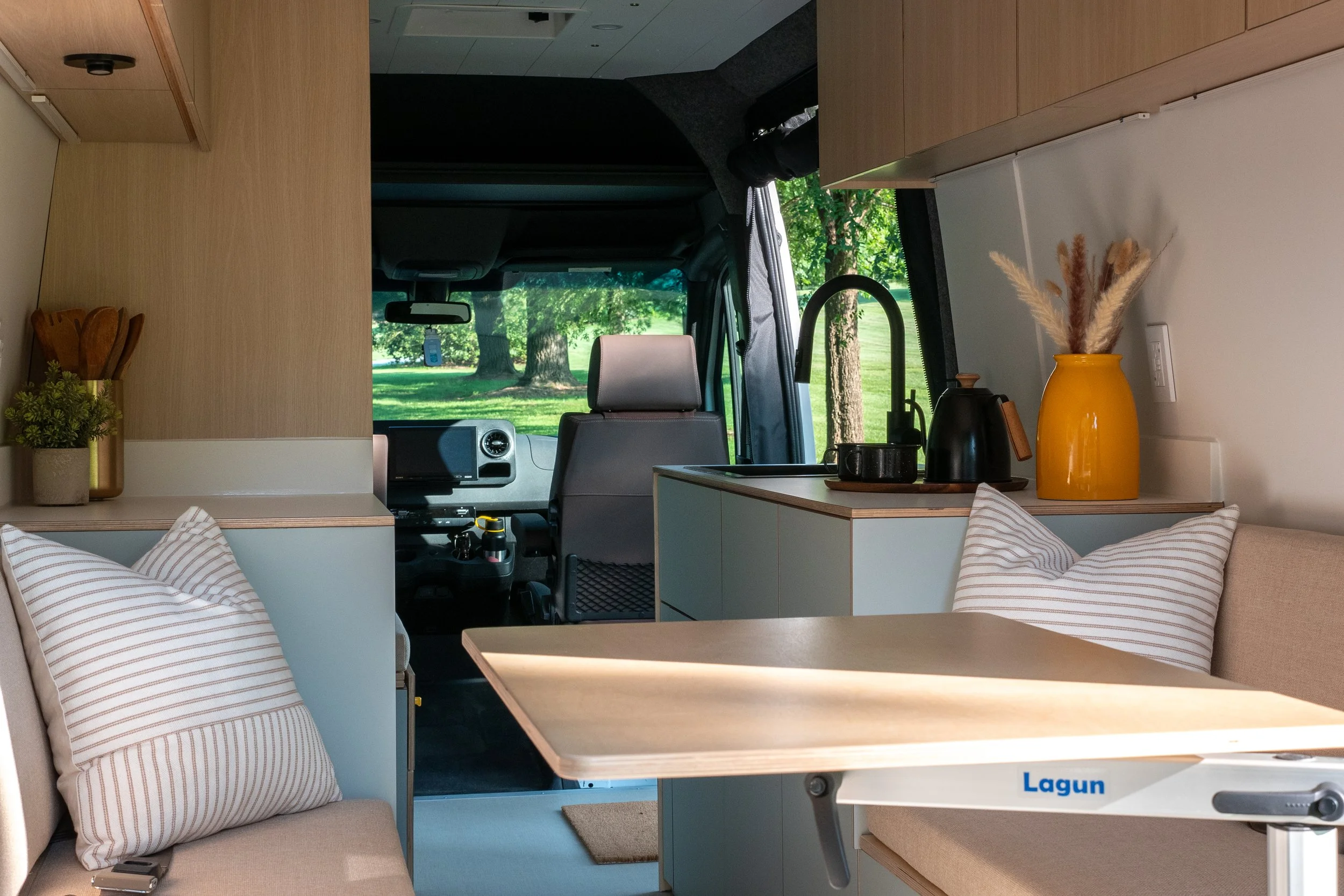 Reserve Series custom van conversion interior — bench seating and Lagun table by Roamer Vans