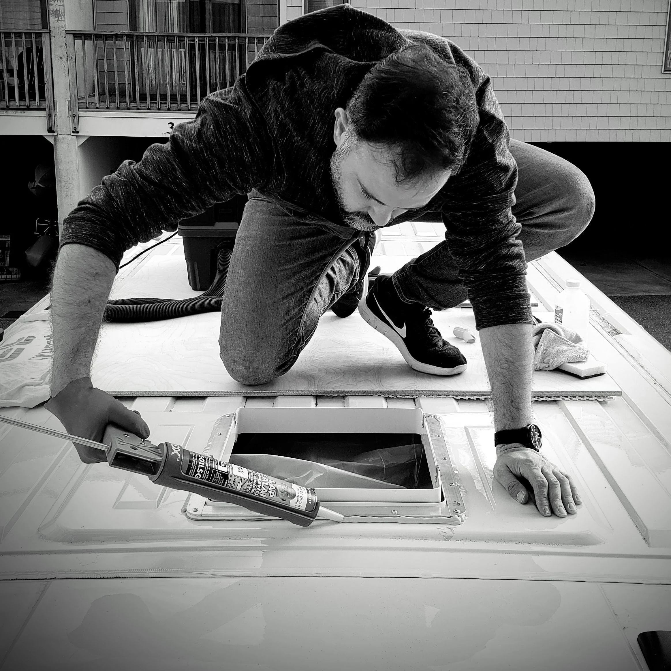 Nick, founder of Roamer Vans, installing a roof vent on a custom campervan conversion in Gaithersburg, Maryland