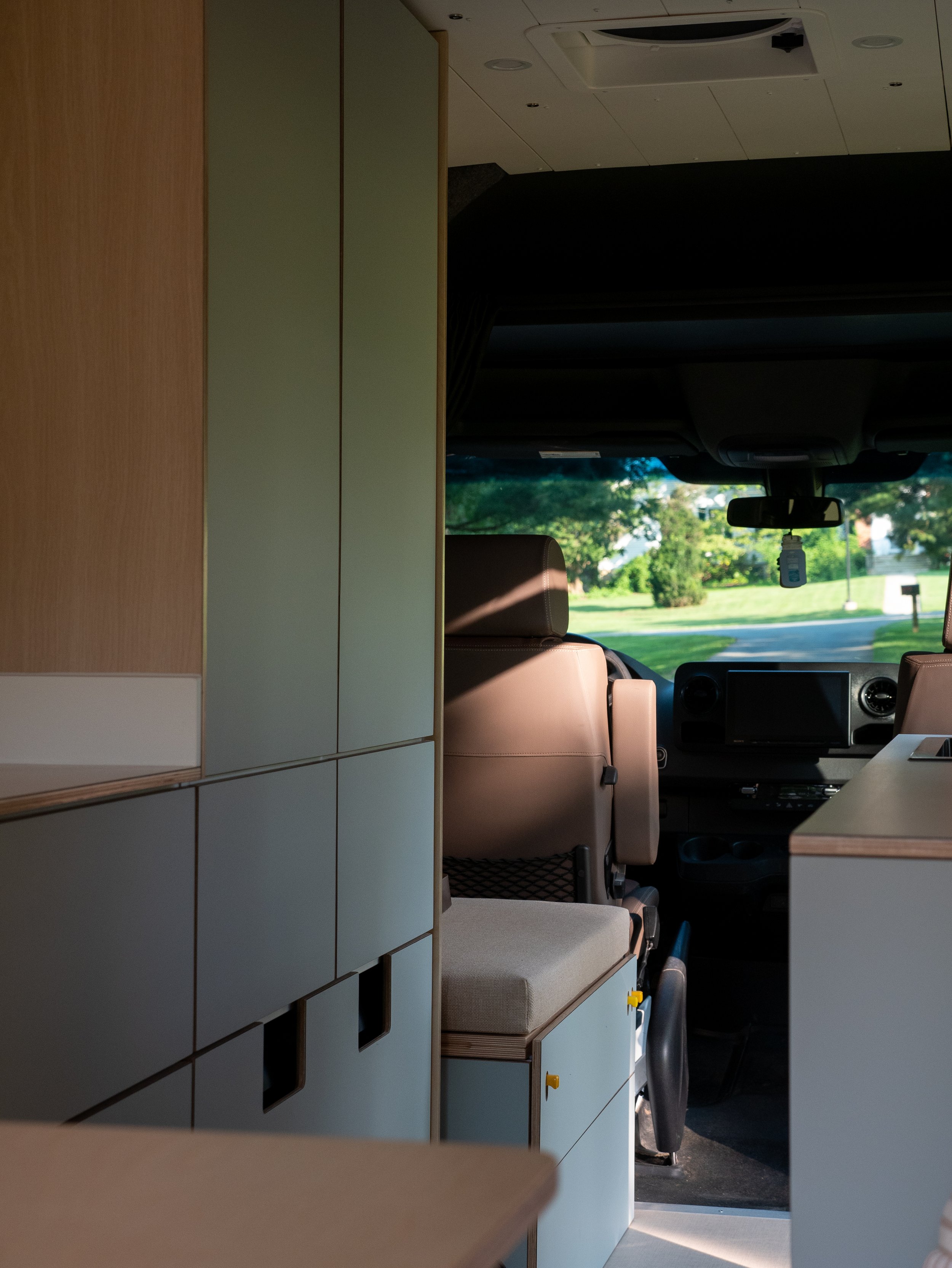 Custom full-height cabinetry and open aisle in Roamer Vans Reserve Series van conversion
