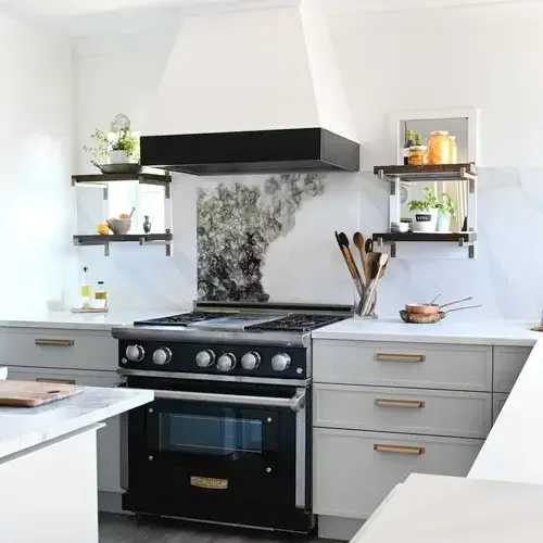  A modern kitchen featuring a stove and oven, with cabinets and countertops visible in the background.
