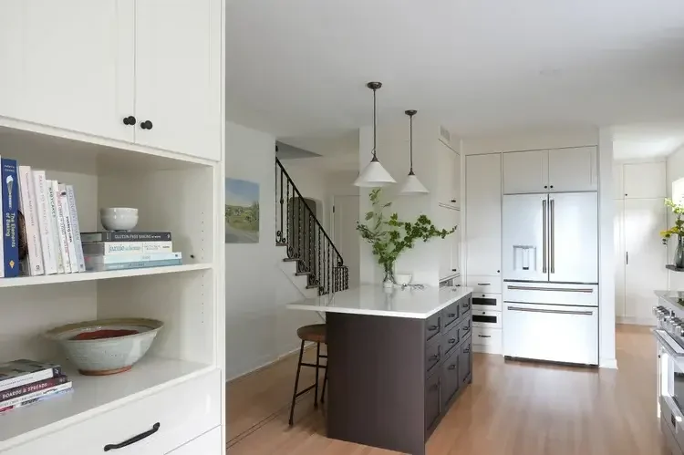 A kitchen featuring a refrigerator, stove, and sink, showcasing a functional cooking space.