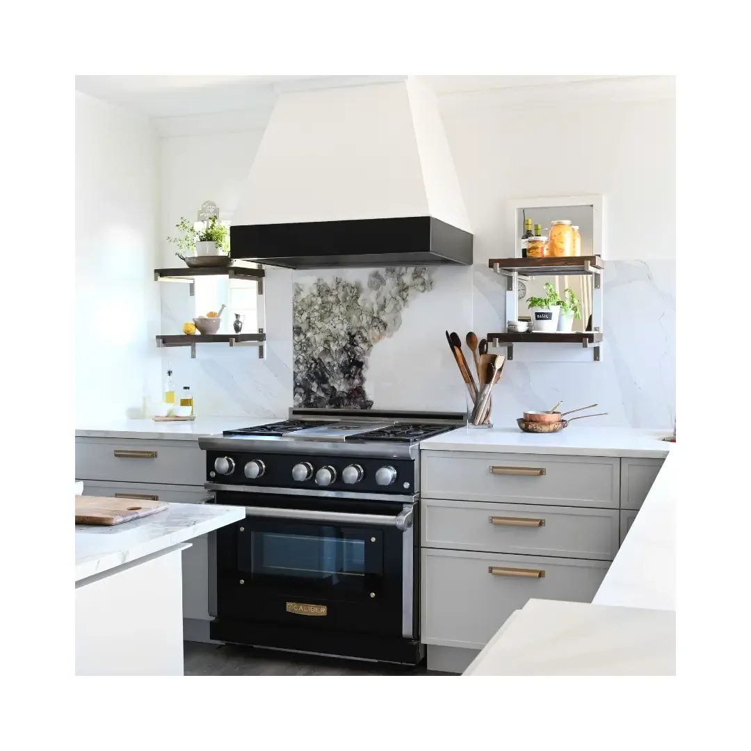 A kitchen featuring a stove, oven, and sink, showcasing a functional cooking space with modern appliances.
