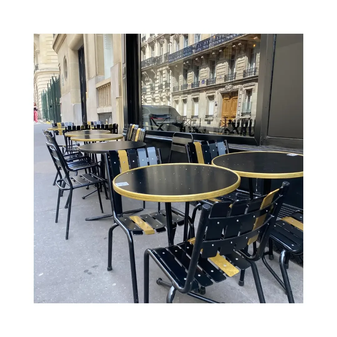 A row of black and yellow chairs arranged outside a cafe, inviting patrons to sit and enjoy their surroundings.