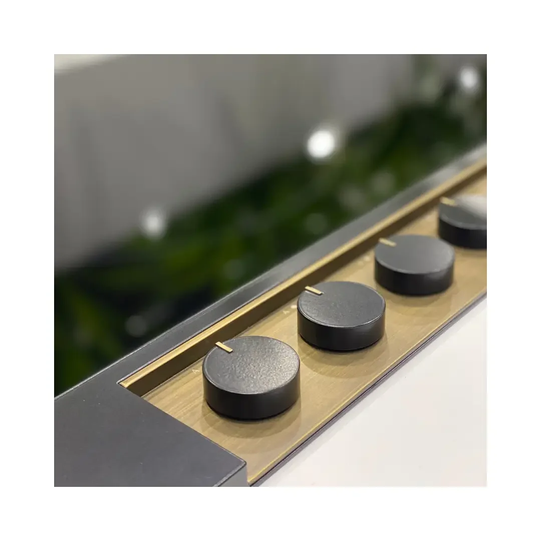 Close-up of four black buttons arranged on a metallic shelf, showcasing their texture and design.