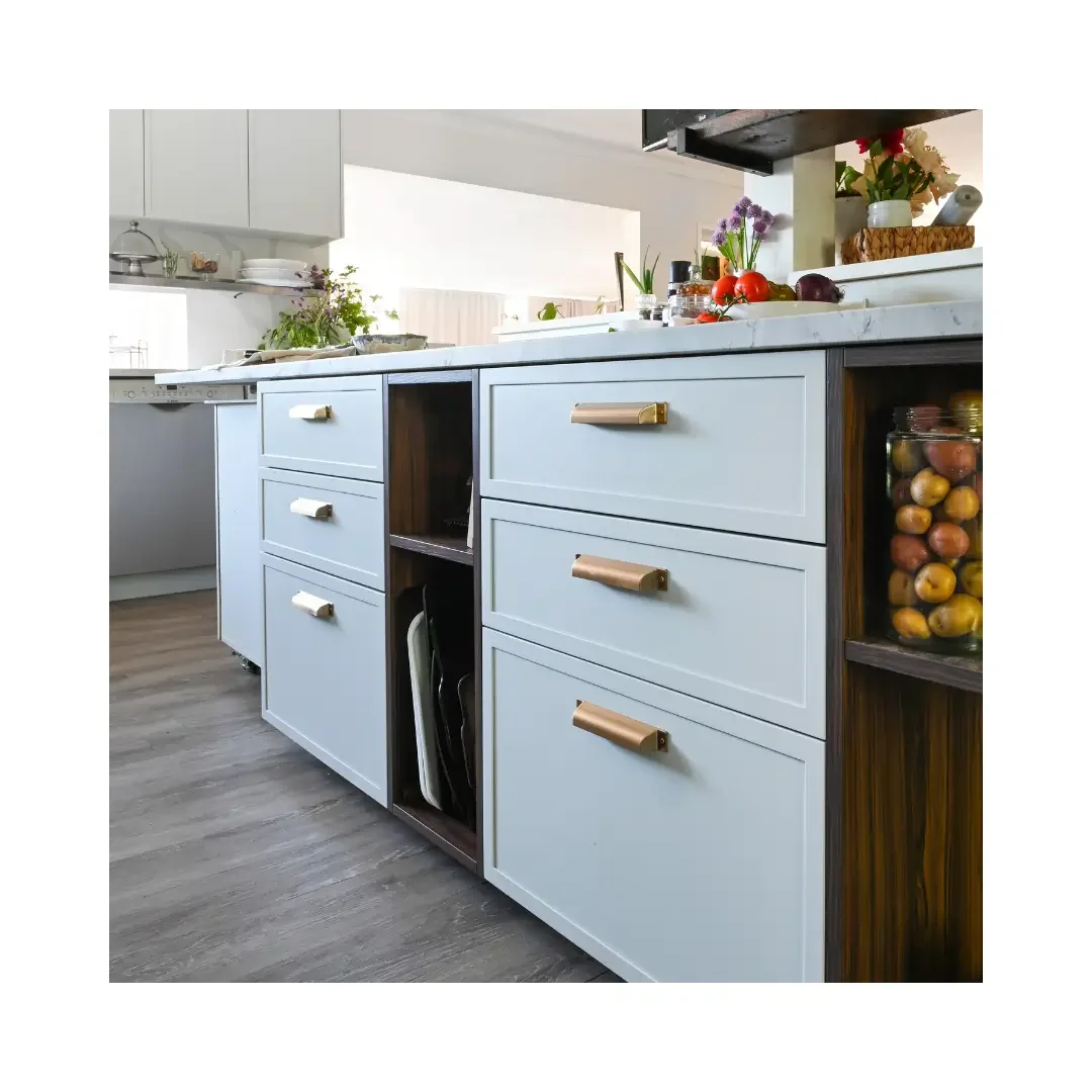 A modern kitchen featuring white cabinets with wooden handles, creating a clean and inviting atmosphere.