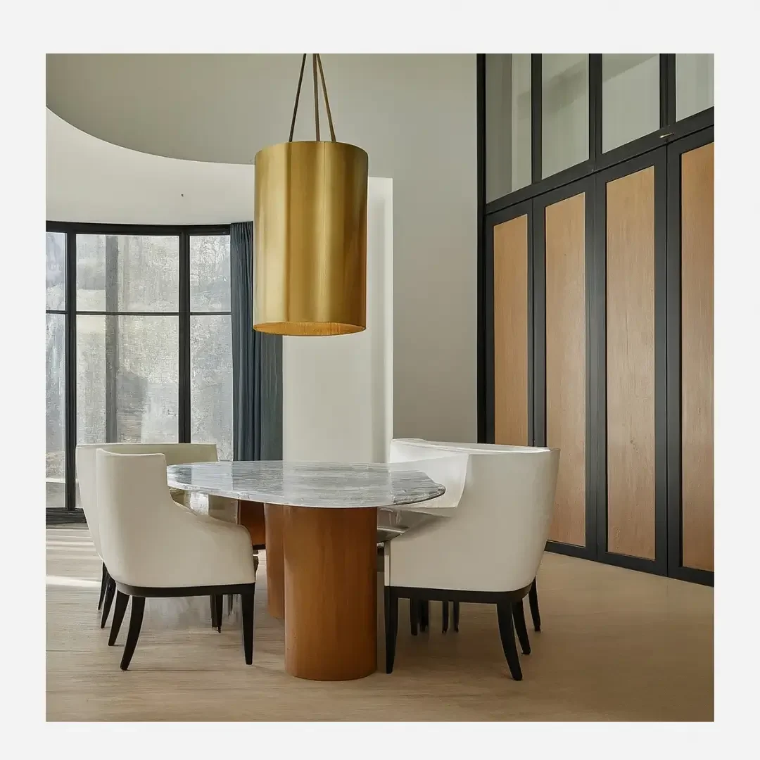 A modern dining room featuring a large pendant light hanging above a sleek dining table and stylish chairs.