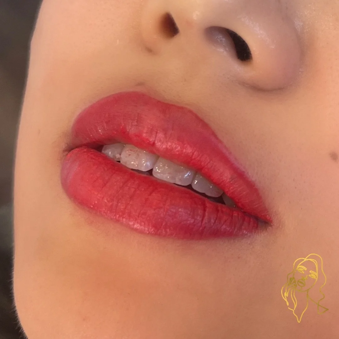 Close-up of a person's lips with red lipstick, slightly open revealing teeth, and nose visible above the lips.