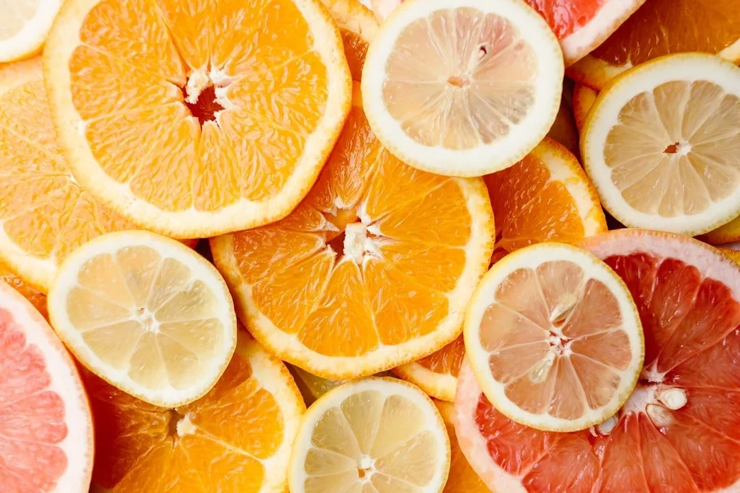 Citrus slices of fruits including orange, grapefruit and lemons. Orange, pink and yellow colors.