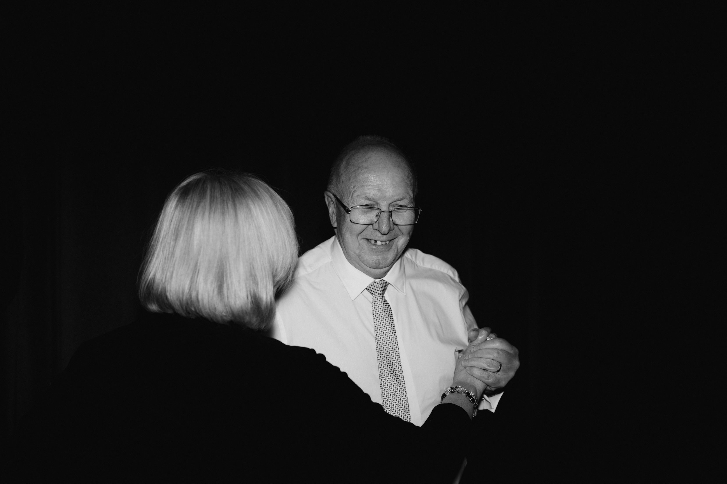 Black and white photo of an elderly couple dancing