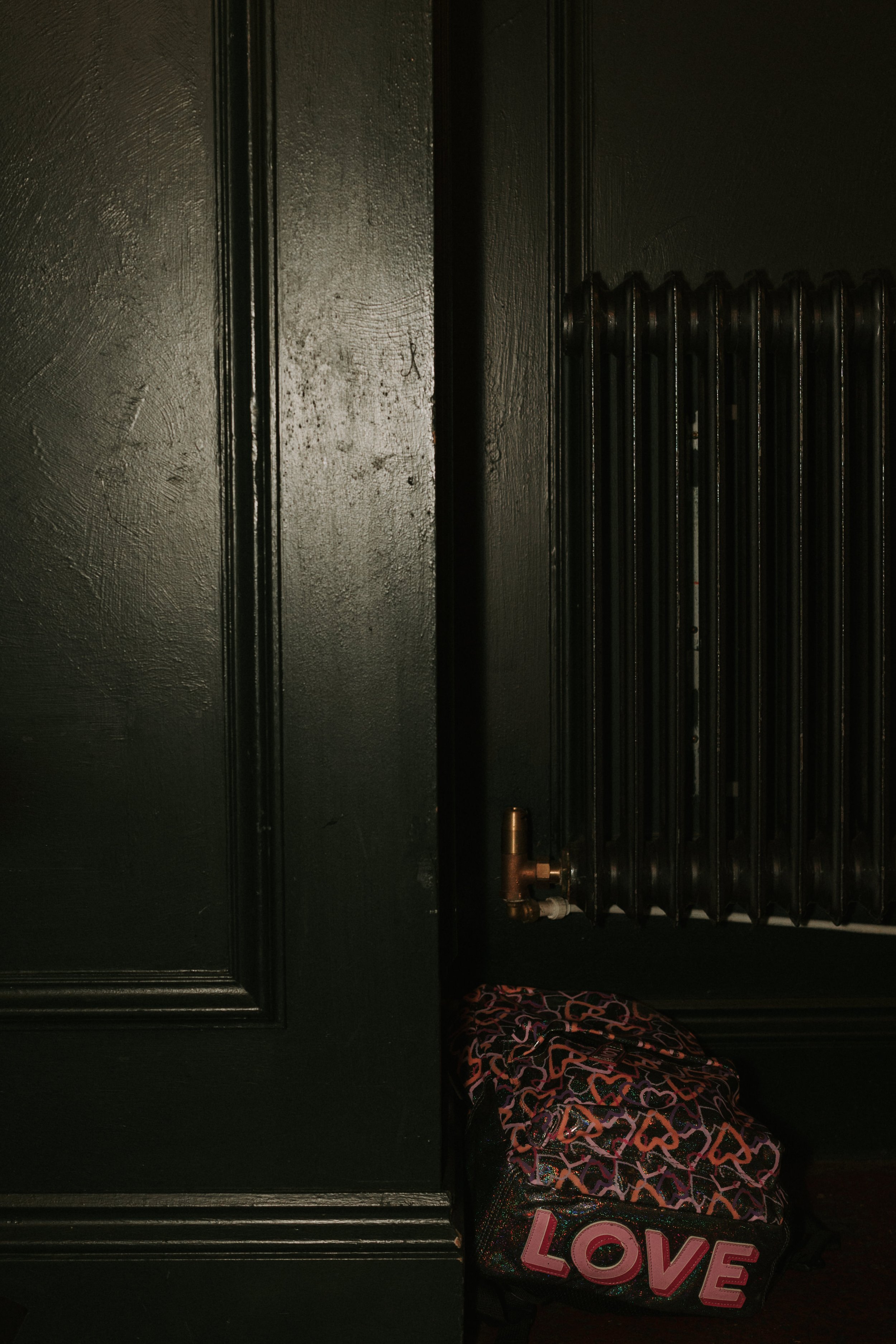 Dark room with radiator and bag with 'LOVE' lettering
