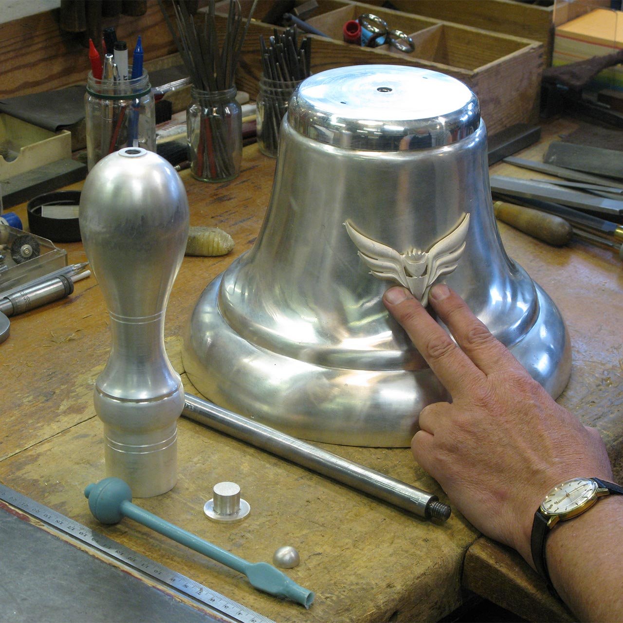 british-silverware-quipco-bell-on-bench-pre-assembly.jpg