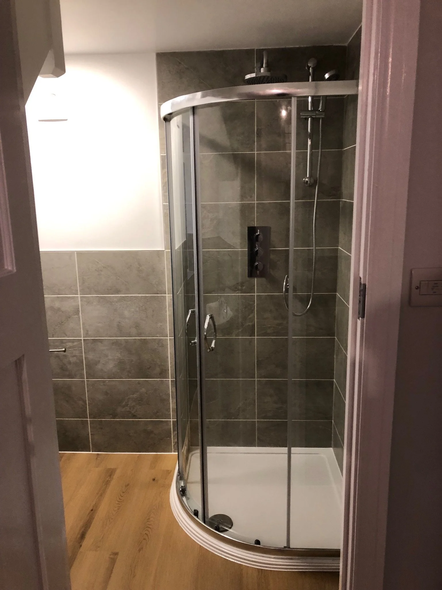 Another bathroom with new tiles and a walk in shower