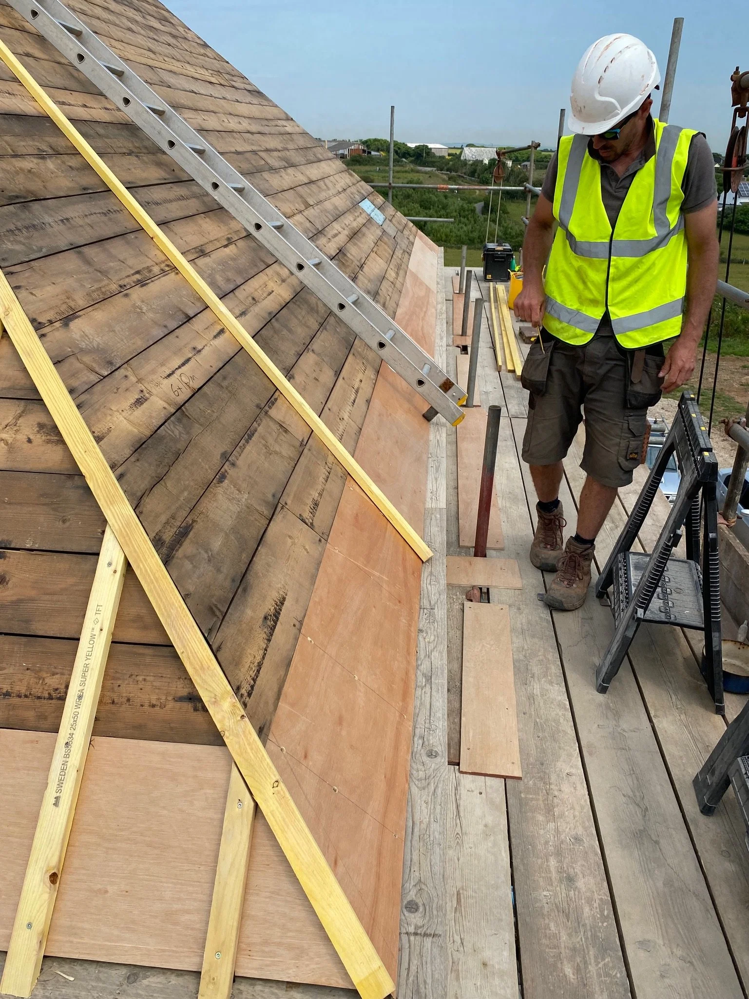 A TP Works tradesperson working on the roof timbers