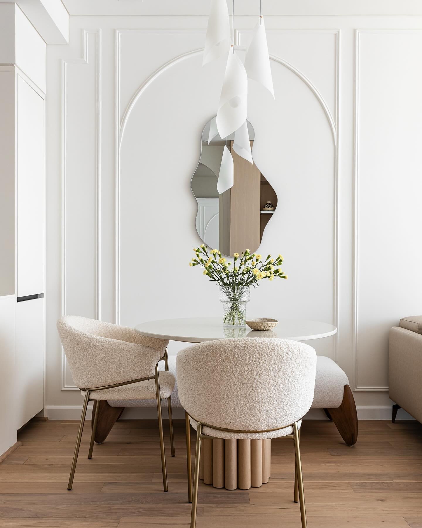 Client: give me modern organic elegance 
Us: 🪄 

Since the space wasn&rsquo;t large we wanted the dining area to be its own zone. We played with arched shape for the wall moulding and introduced an organic mirror as a focal point, creating an illusi