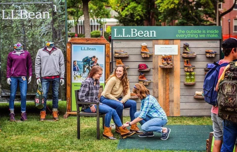 helping customers try on boots