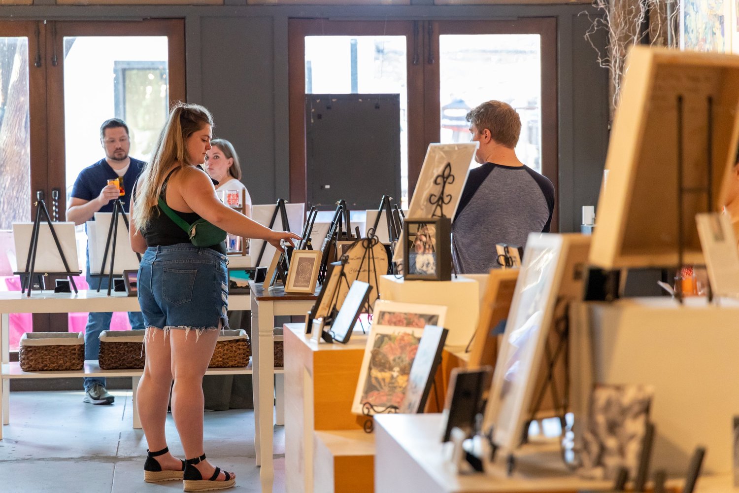Visitors browsing artwork at a Deep Ellum community gathering