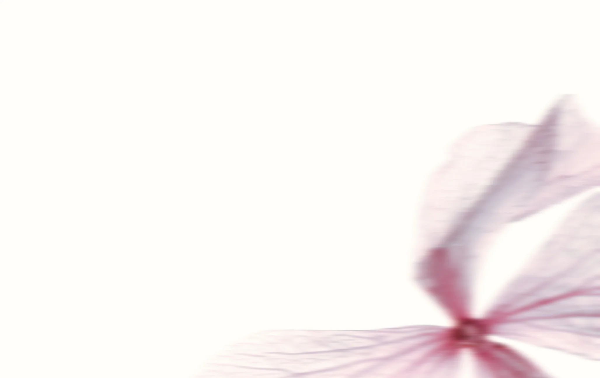 A blurred image of a person in motion, with a reddish-pink hue and streaks suggesting movement or speed.