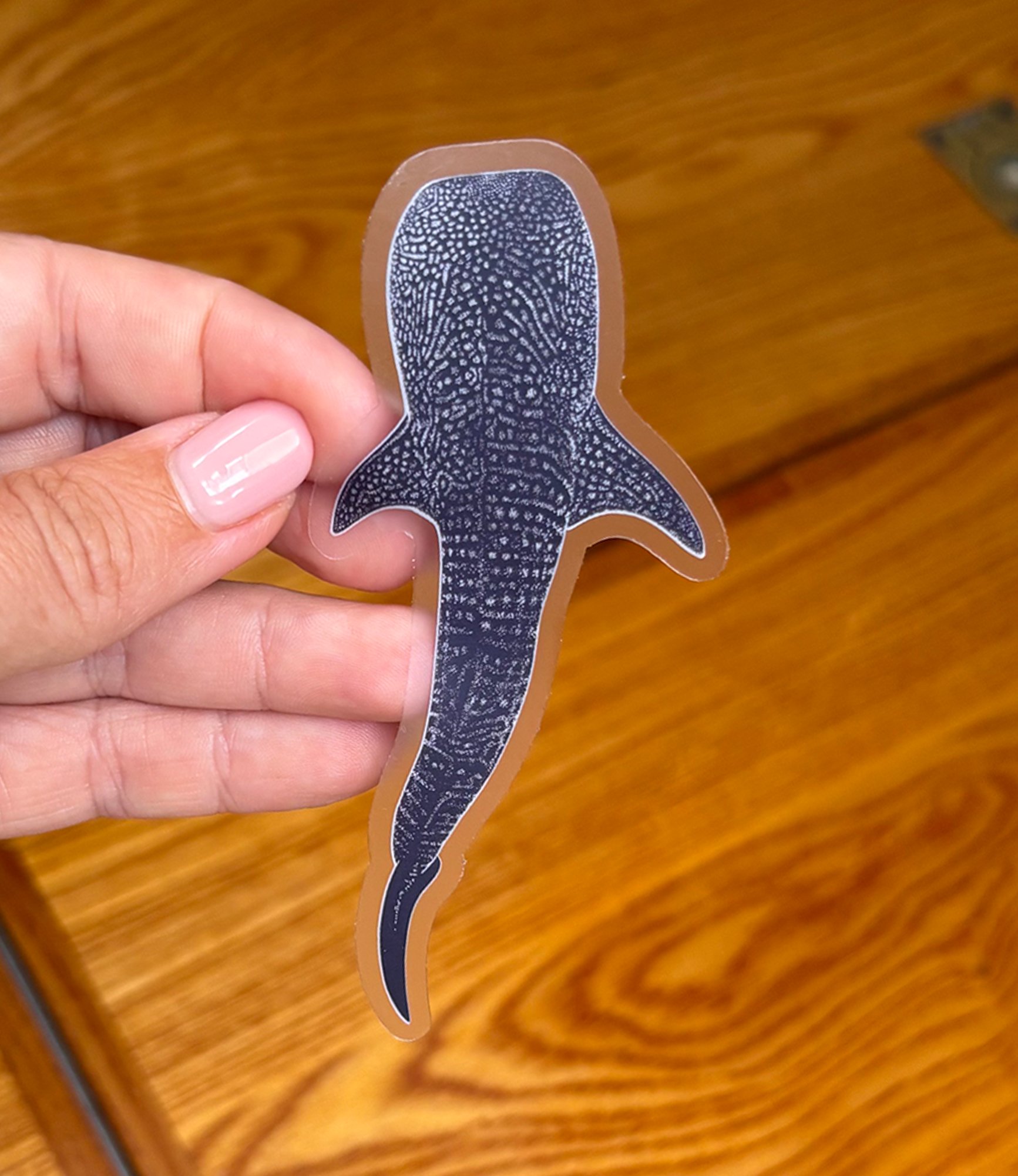 Clear Whale Sticker against wood.jpg