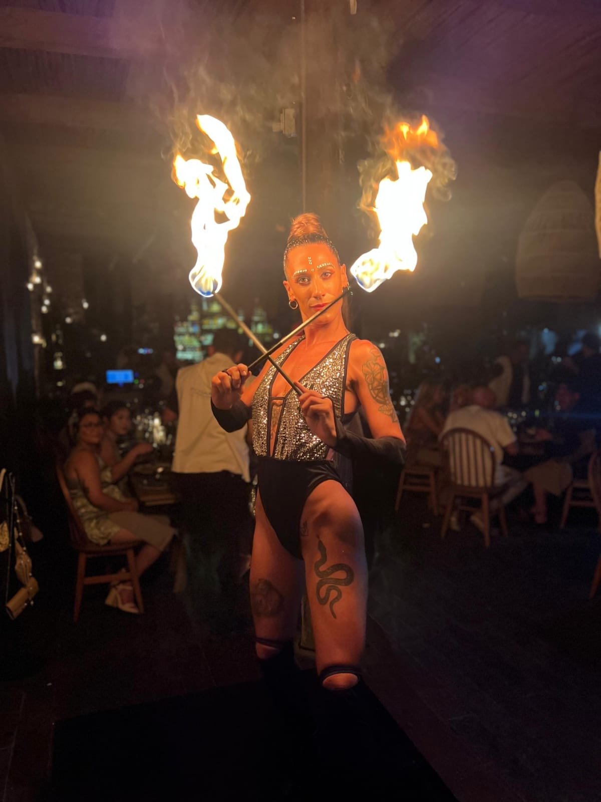 A female fire show performing a fire act during a private chef service in Tulum.