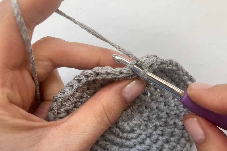 Simple round crochet basket pattern finished in neutral colours for home organisation