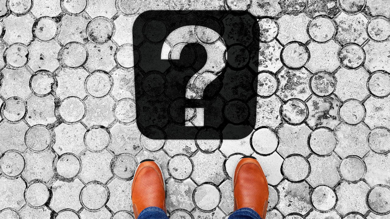 Checkmark on pavement with work shoes pointing at them