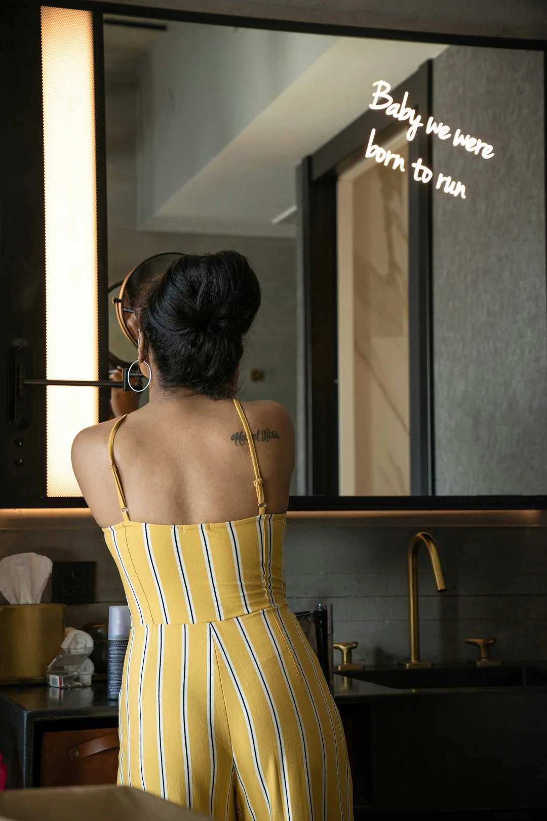 Confident woman in yellow looking in mirror embodying self-worth and dating readiness