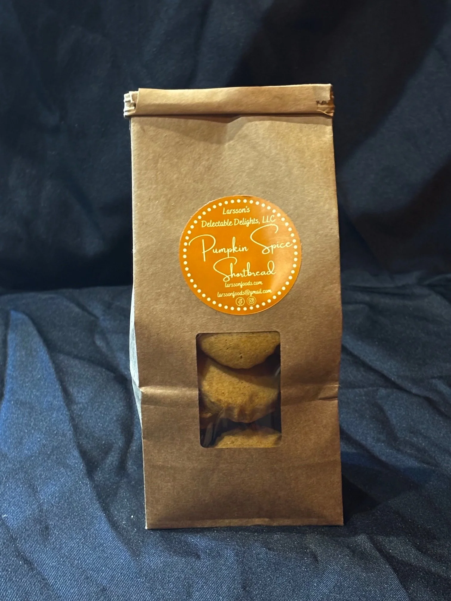 A bag of mini Pumpkin Spice Shortbread set in front of a black background
