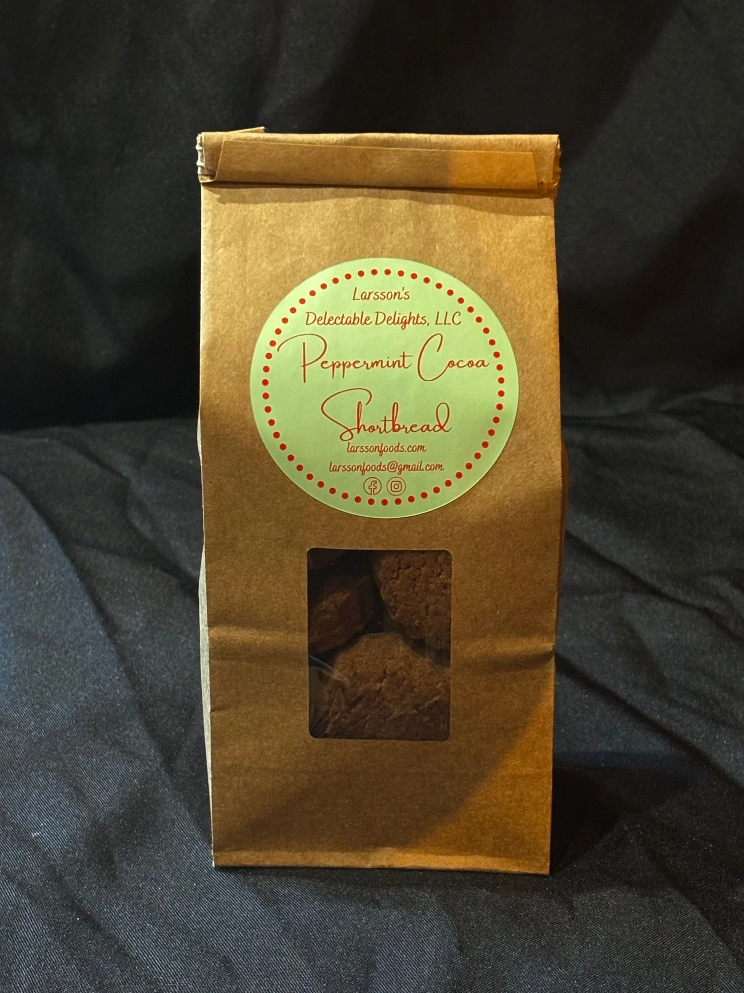 A bag of mini Peppermint Cocoa Shortbread set in front of a black background