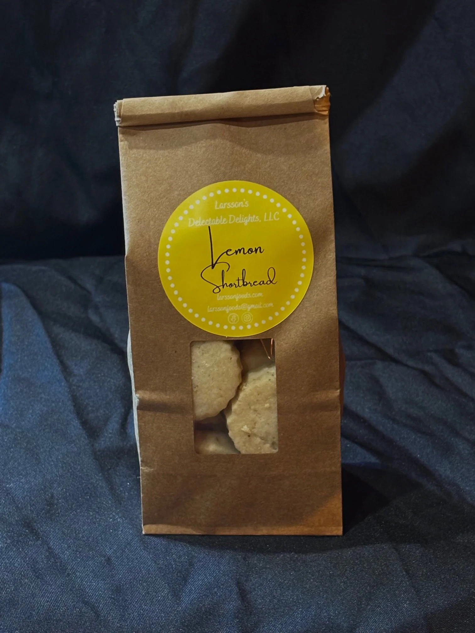 A bag of mini Lemon Shortbread set in front of a black background
