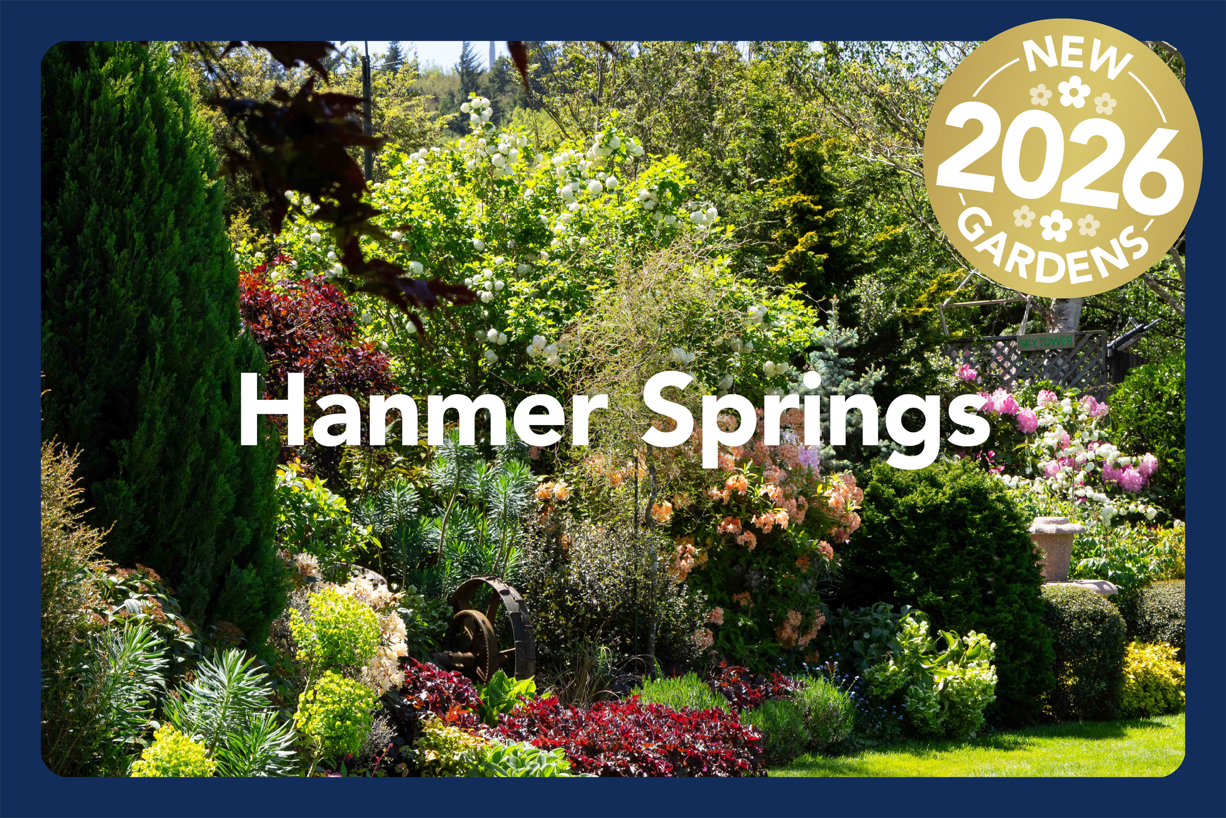 Lush garden with blooming flowers, green bushes, and trees in spring. Includes a sign that says 'Sky Tower' with a large gold badge in the top right corner that reads 'New 2026 Gardens'.