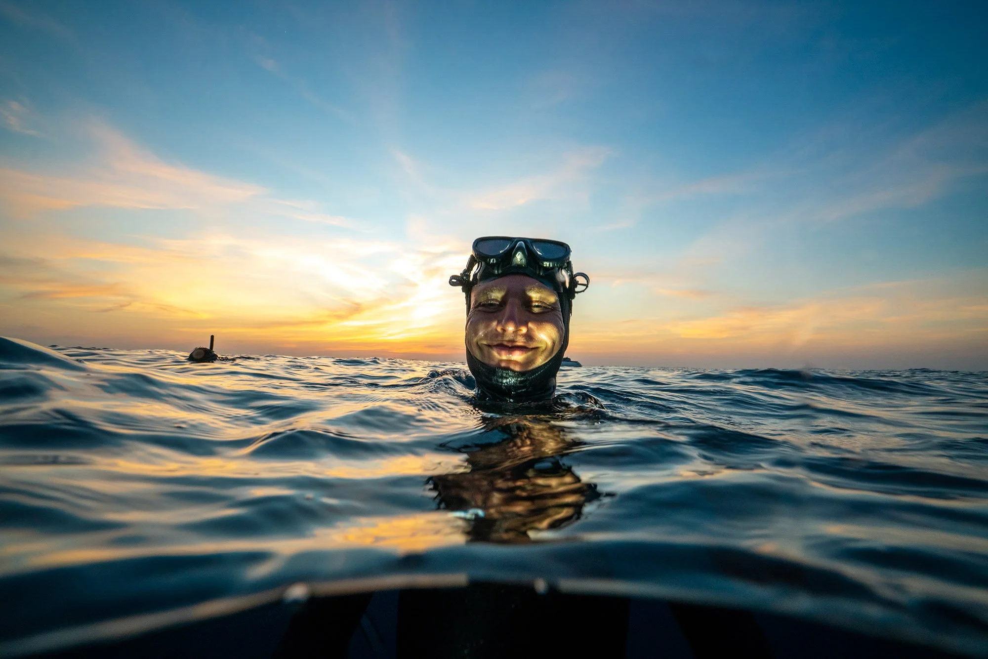 Freediver smiling at ocean surface during sunset cruise with Orenda Freediving in Koh Tao Thailand