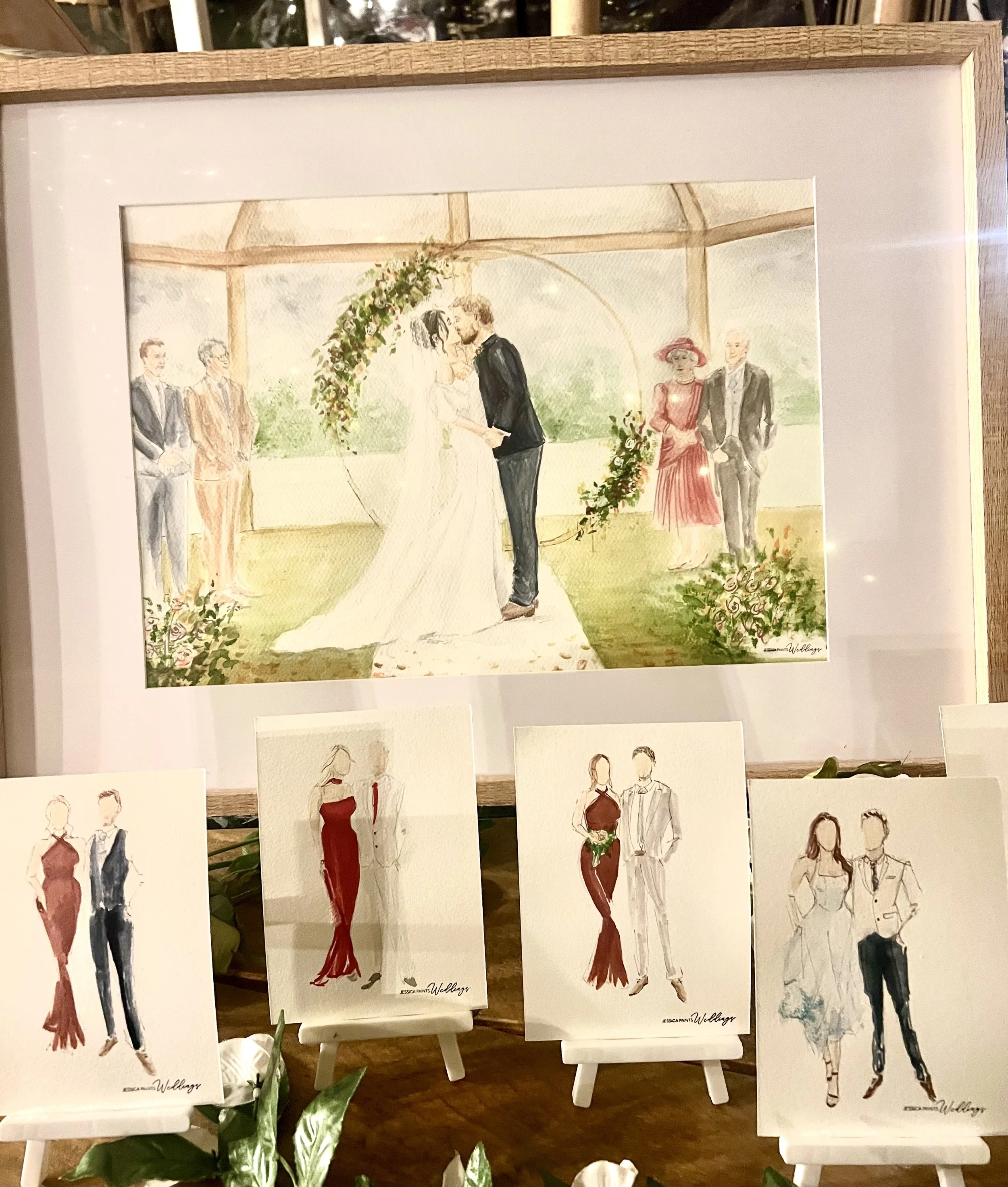 a watercolour painting of the bride and groom and passed loved ones with wedding guest illustrations in Wales wedding venue